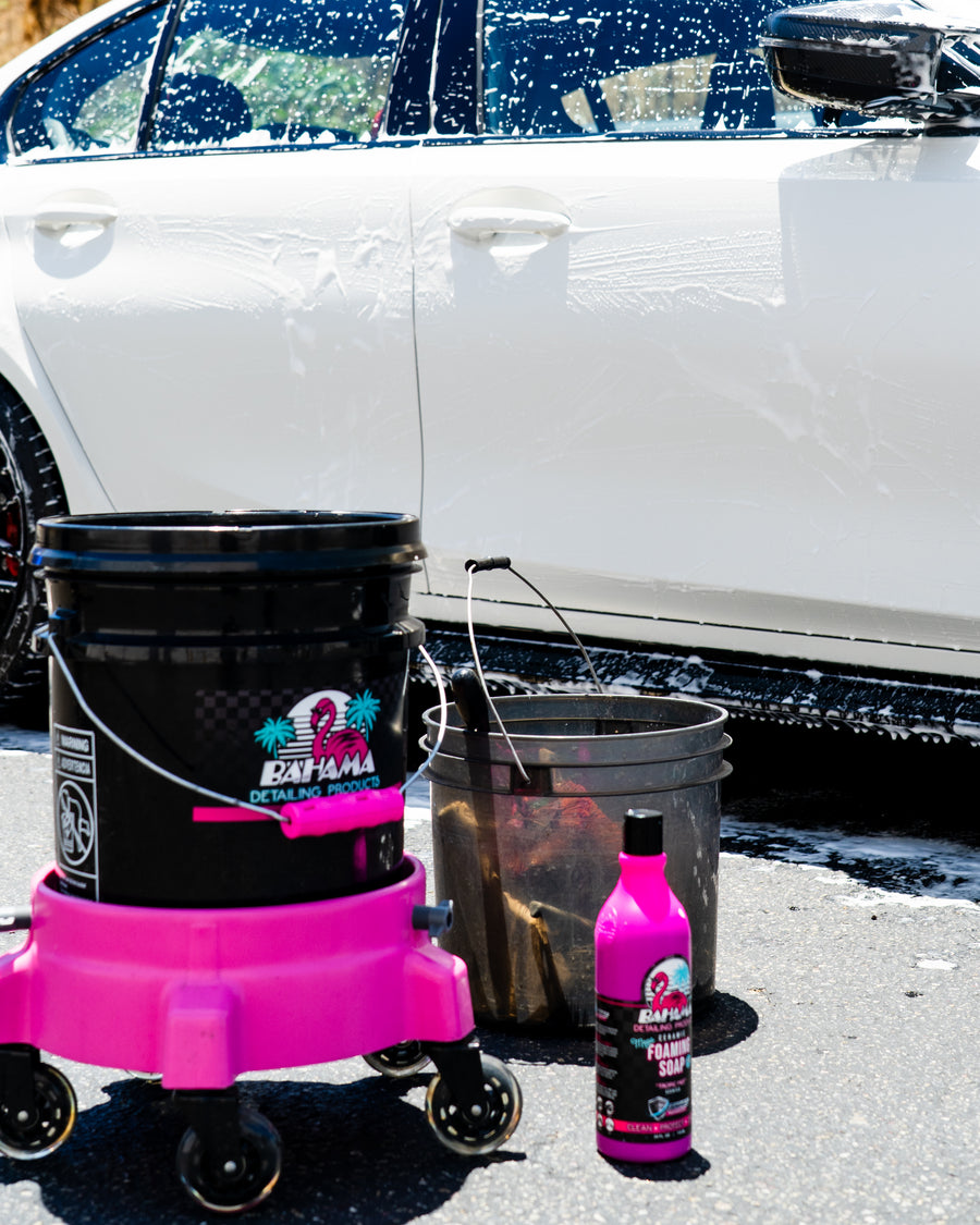 Bahama foaming soap and wash bucket beside a foamed car