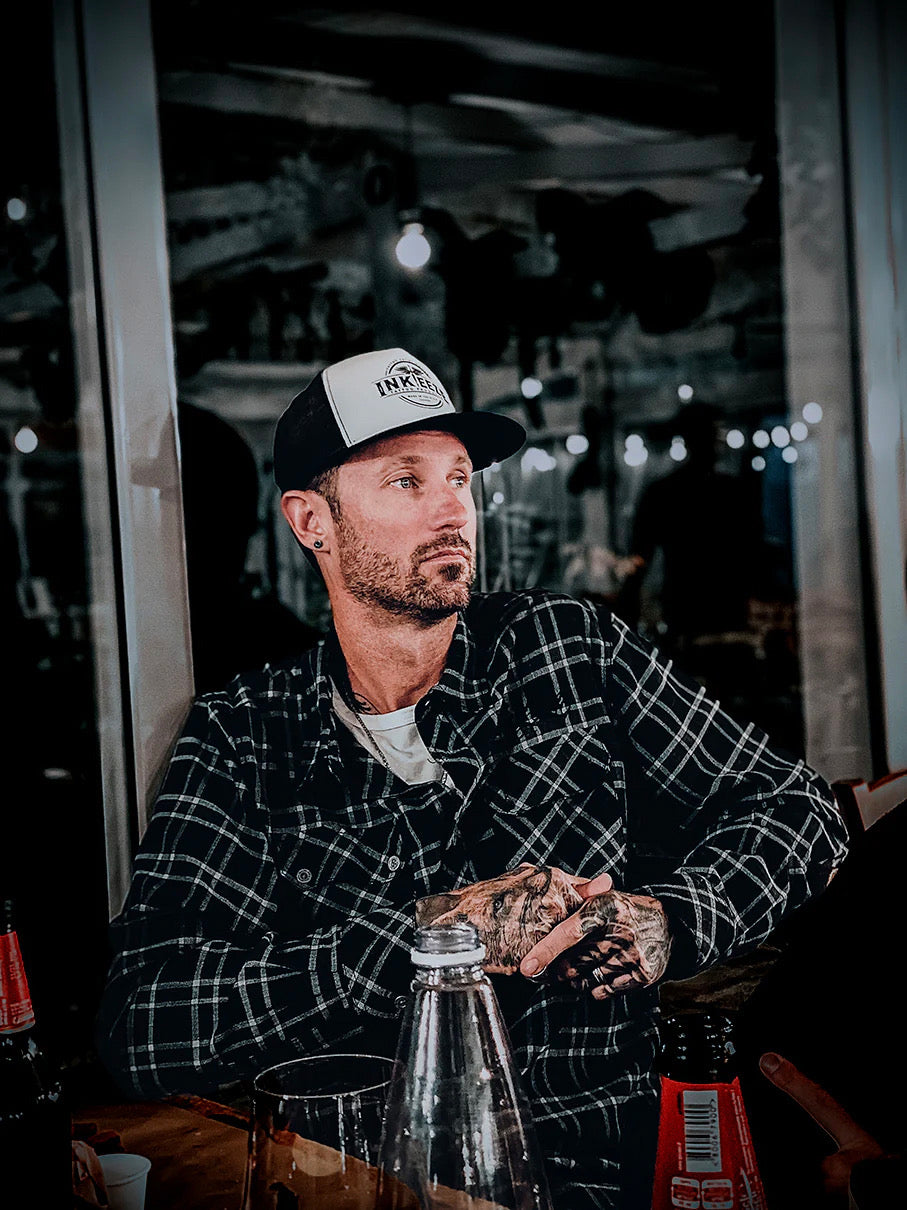 Sean Hoy, founder of Bahama Detailing Products, in a black and white flannel and cap.